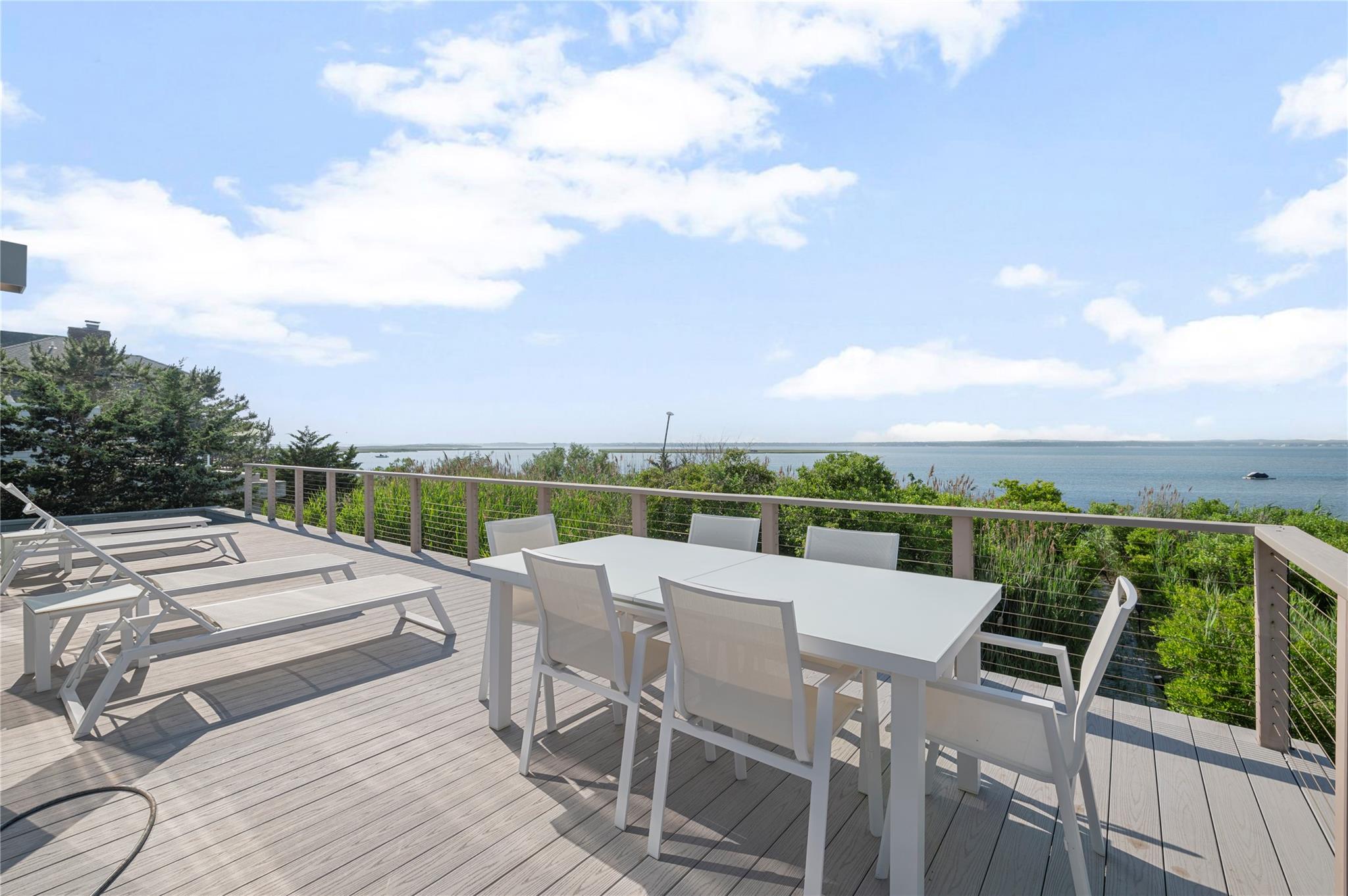 846 Dune Road West Hampton Dunes, NY 11978 - Photo 26 of 49 a view of a roof deck with couches and sky view