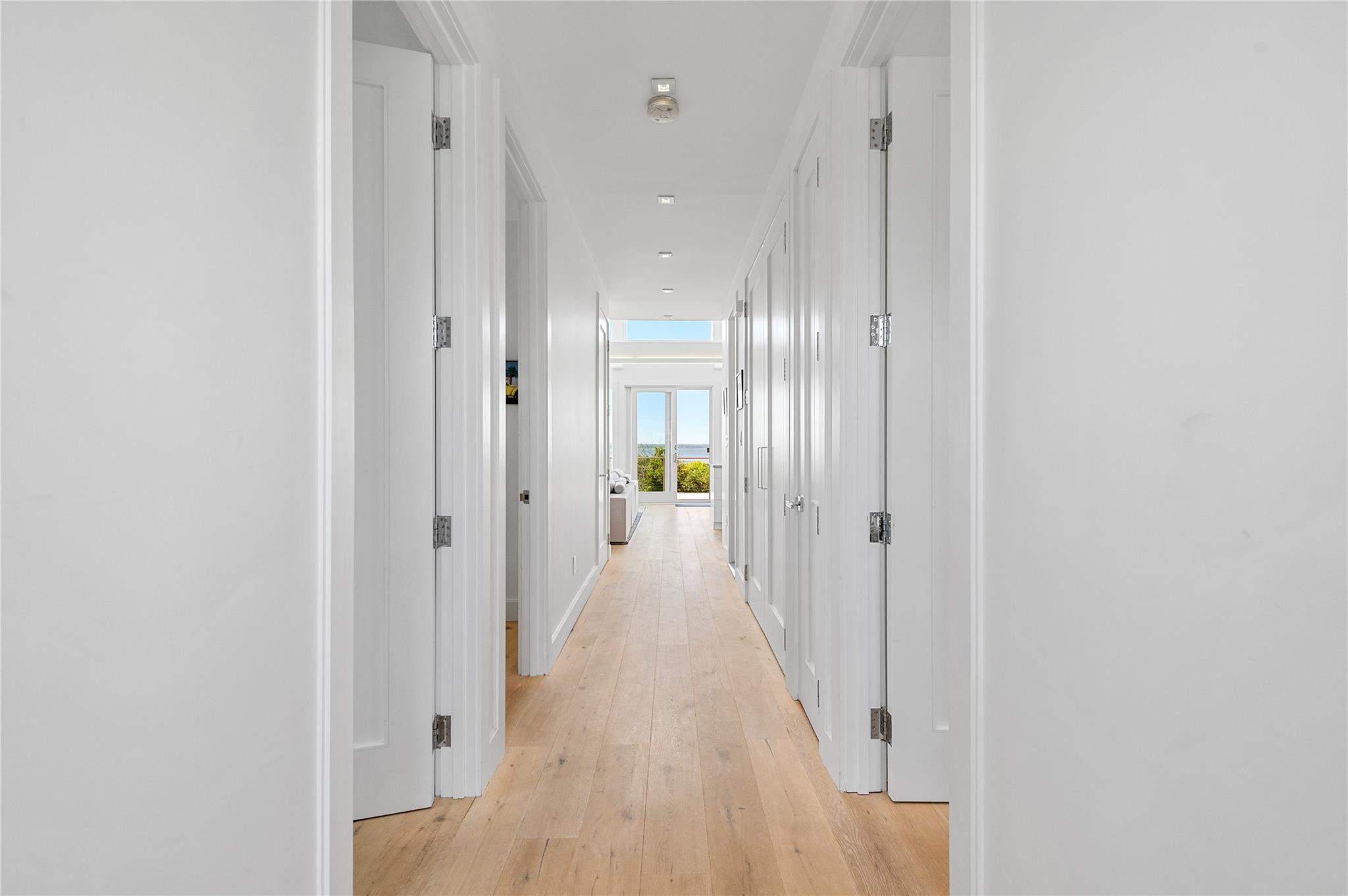 846 Dune Road West Hampton Dunes, NY 11978 - Photo 27 of 49 a view of a hallway with wooden floor and a bathroom