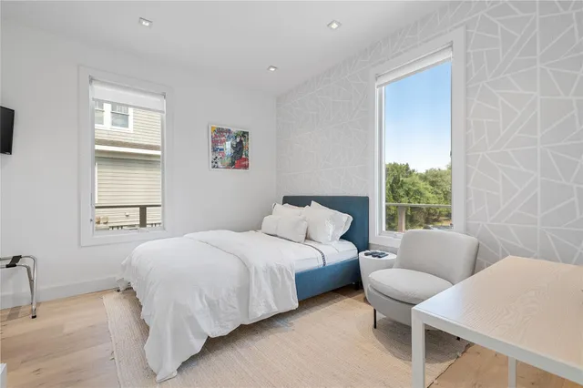 a bedroom with a bed and flat screen tv