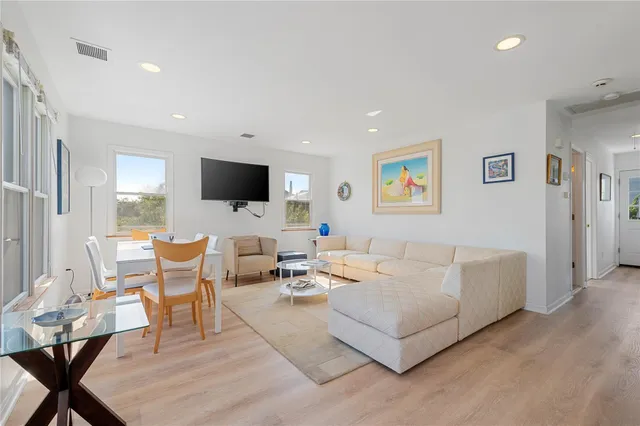 a kitchen with kitchen island granite countertop stainless steel appliances a stove sink microwave and refrigerator