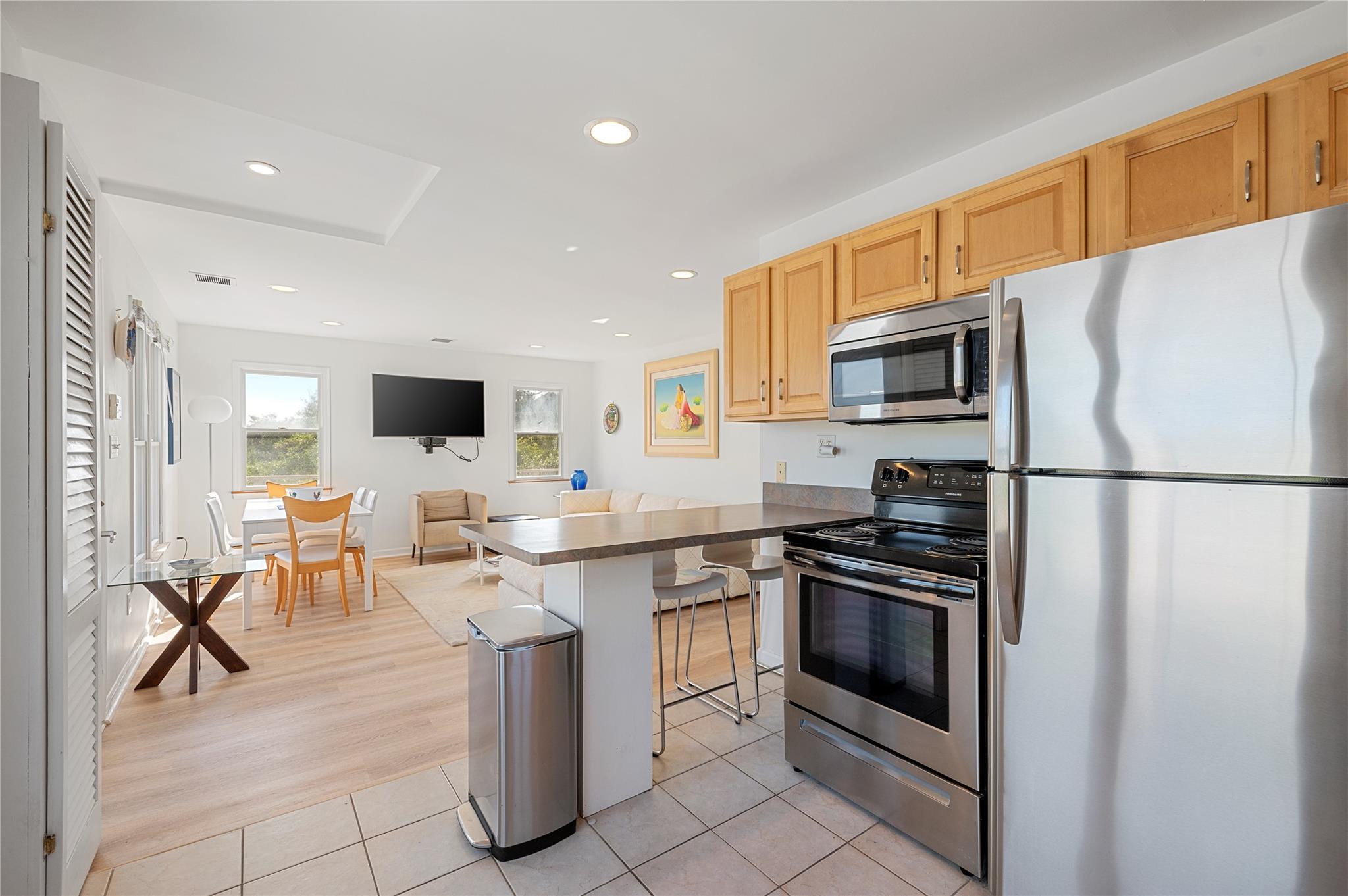 846 Dune Road West Hampton Dunes, NY 11978 - Photo 36 of 49 a kitchen with stainless steel appliances granite countertop a stove top oven a sink dishwasher a refrigerator and a microwave