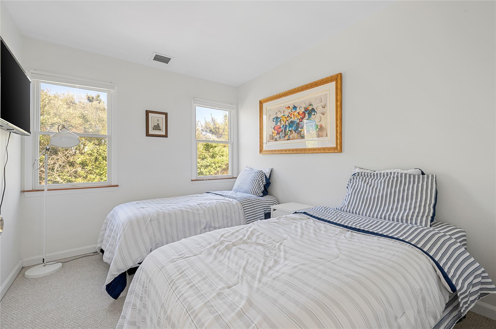 846 Dune Road West Hampton Dunes, NY 11978 - Photo 38 of 49 a bedroom with two beds and a window