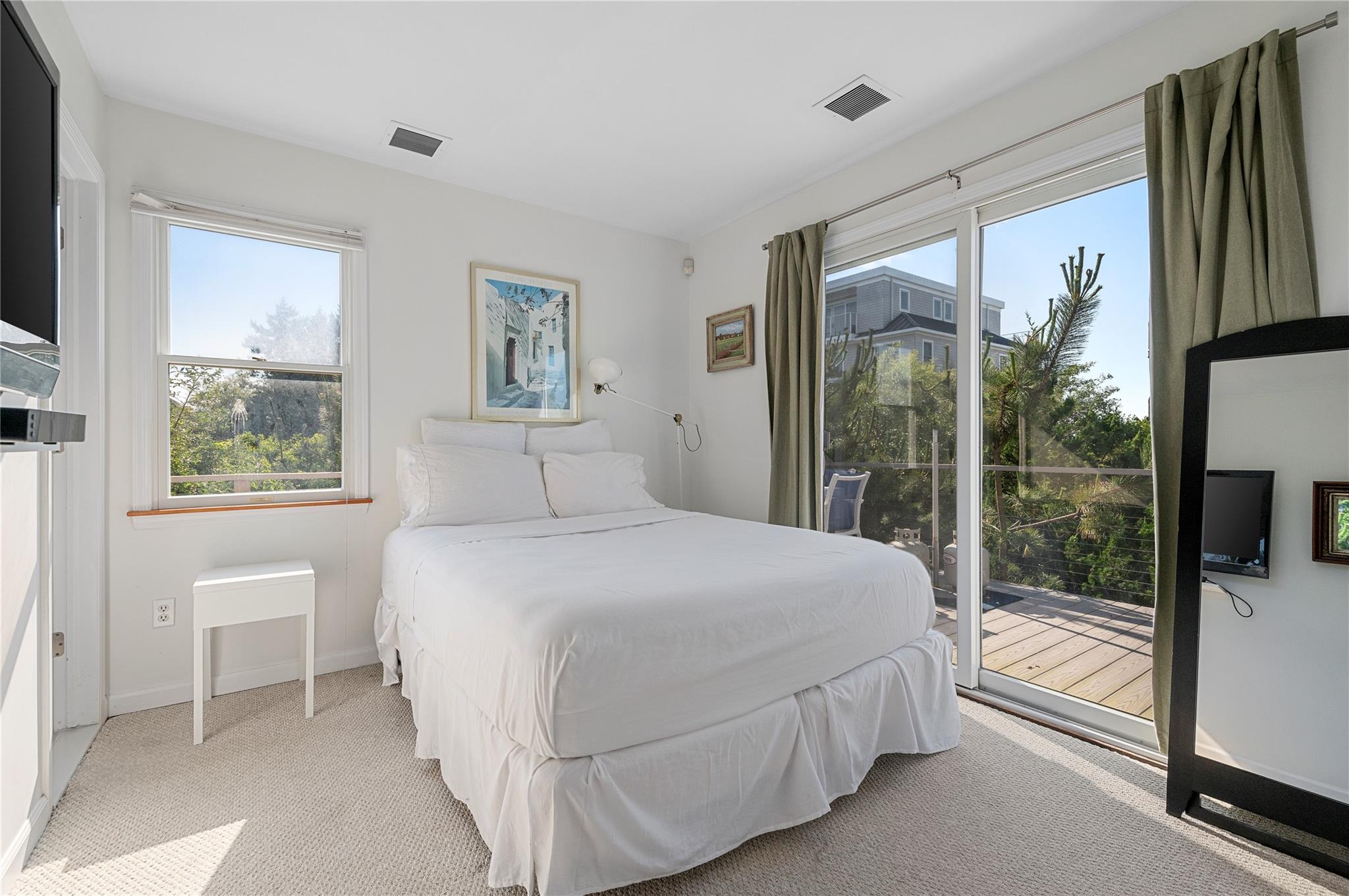 846 Dune Road West Hampton Dunes, NY 11978 - Photo 40 of 49 a bedroom with a large bed and a large window