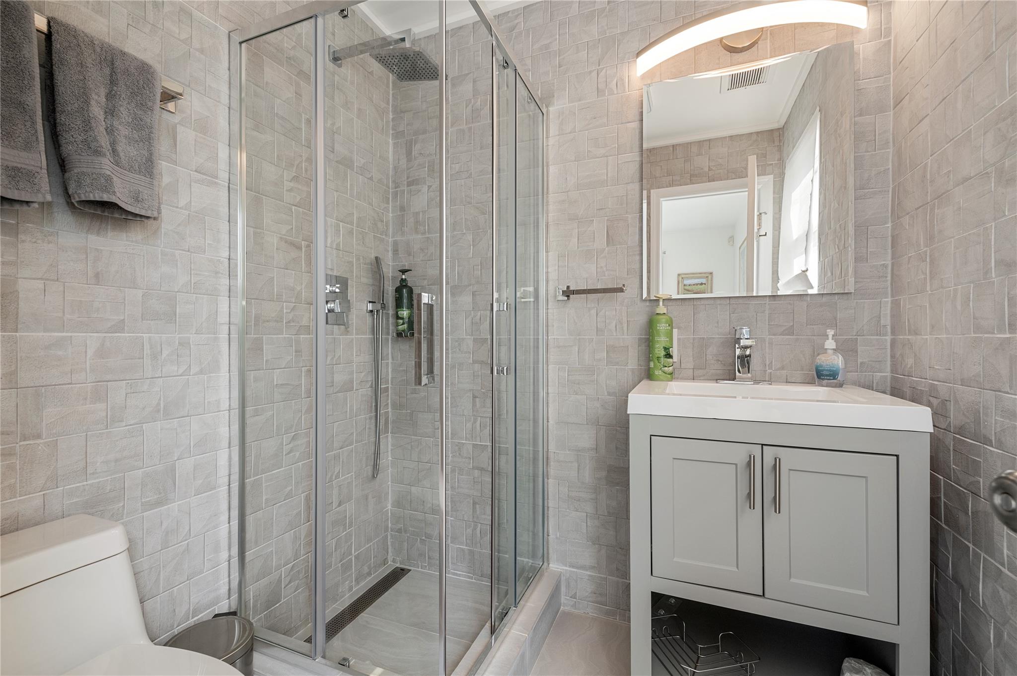 846 Dune Road West Hampton Dunes, NY 11978 - Photo 41 of 49 a bathroom with a sink a toilet and shower