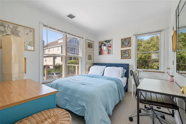 a bed sitting in a bedroom next to a window