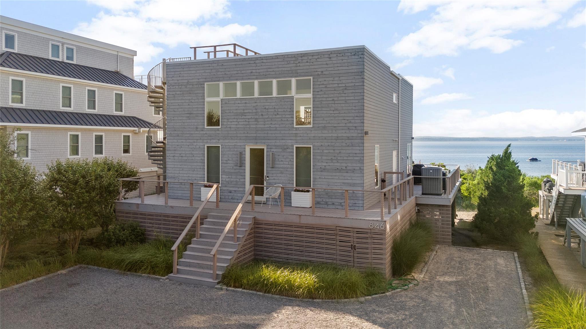 846 Dune Road West Hampton Dunes, NY 11978 - Photo 45 of 49 a front view of a house with garden