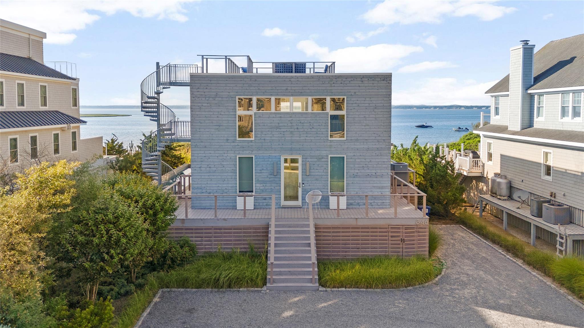846 Dune Road West Hampton Dunes, NY 11978 - Photo 47 of 49 a view of a brick building next to a yard