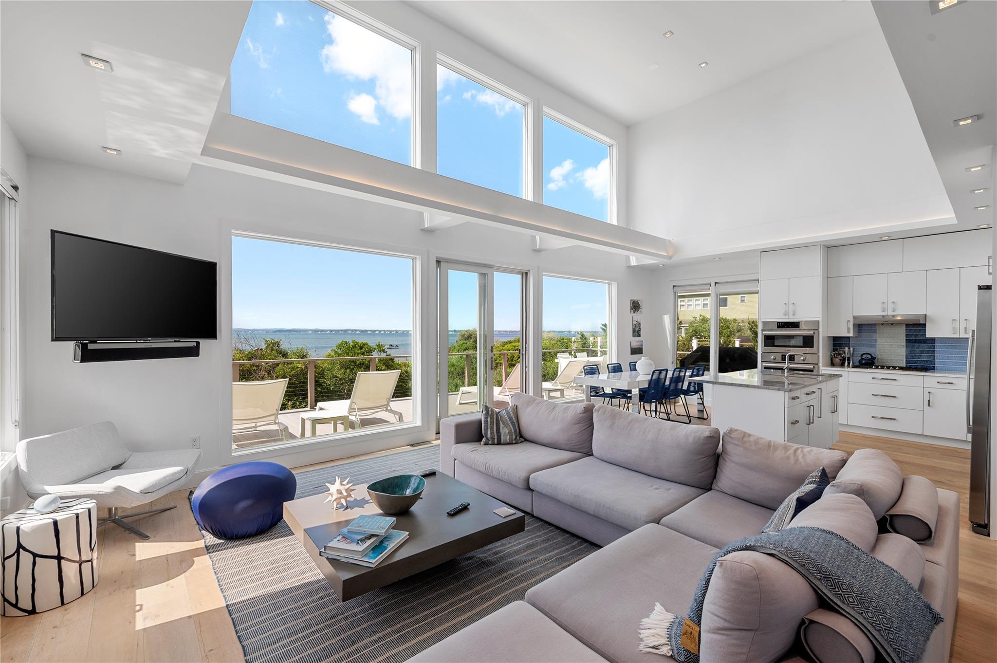 846 Dune Road West Hampton Dunes, NY 11978 - Photo 5 of 49 a living room with furniture and a flat screen tv