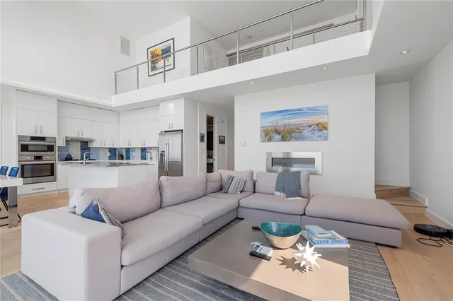 a living room with furniture and view of kitchen