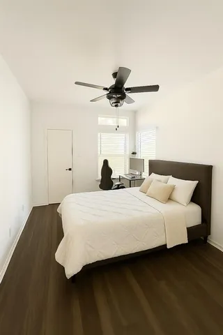 a bedroom with a bed and a ceiling fan
