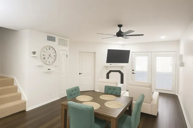 a dining room with furniture and a large window