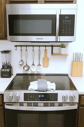 a dining room with furniture and a mirror