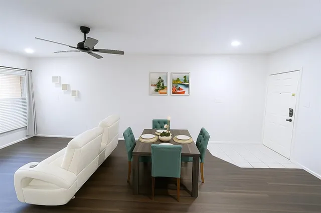 a bedroom with a bed and a ceiling fan