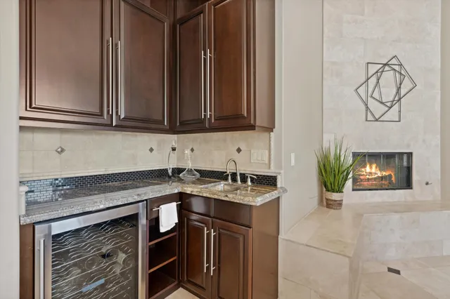 a kitchen with stainless steel appliances kitchen island granite countertop a stove a sink a microwave oven and a dining table