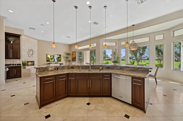 a kitchen with granite countertop a stove top oven microwave and cabinets