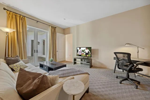 a bedroom with a bed next to a window