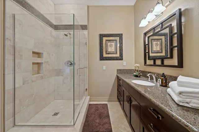 a bedroom with a bed flat screen tv and a large window