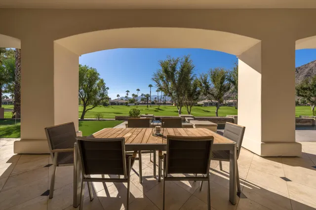 a view of an chairs and table in patio