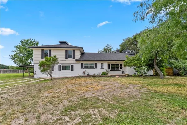 a house that has a tree in front of it