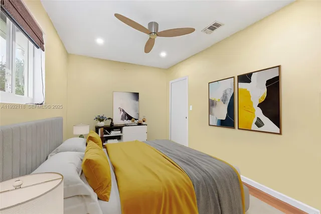 a view of a room with wooden floor and a ceiling fan