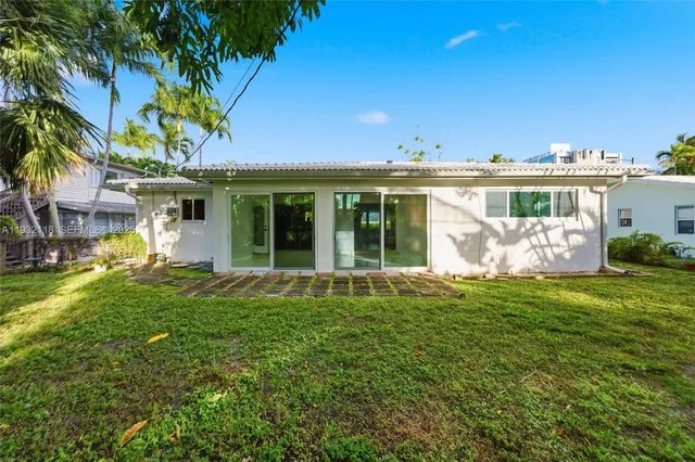 an aerial view of a house with a yard and outdoor seating
