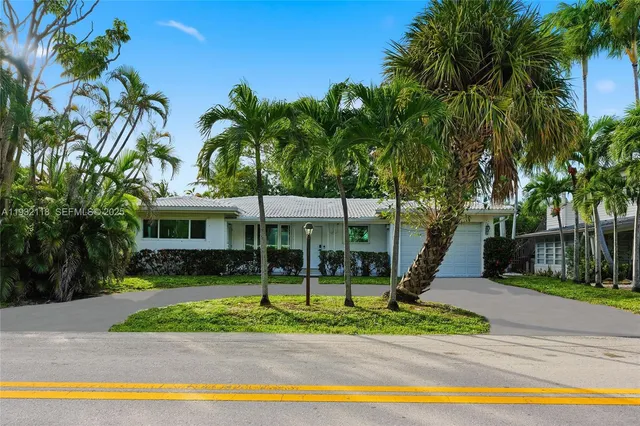 a view of a house with a patio and a yard