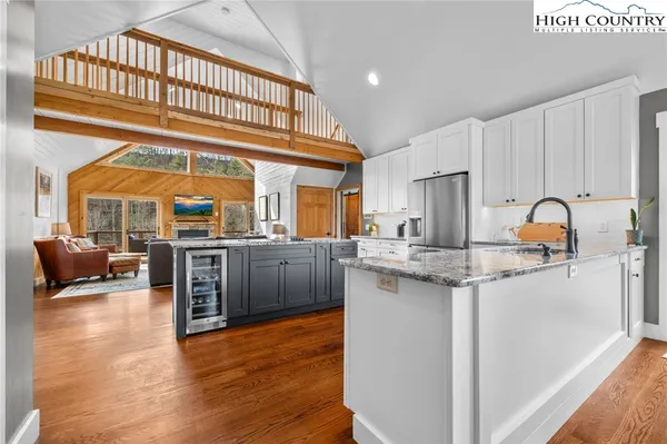 a dining room with furniture a chandelier and wooden floor