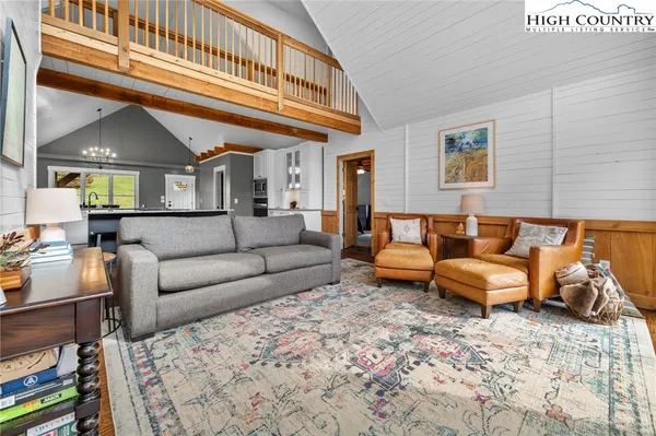 a bedroom with a bed and large windows