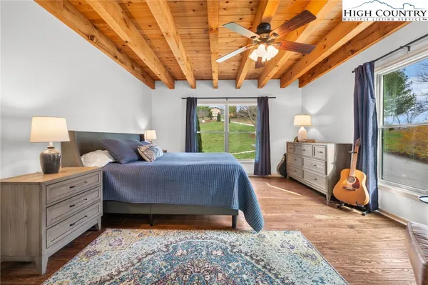 a spacious bathroom with a granite countertop sink a toilet and a mirror