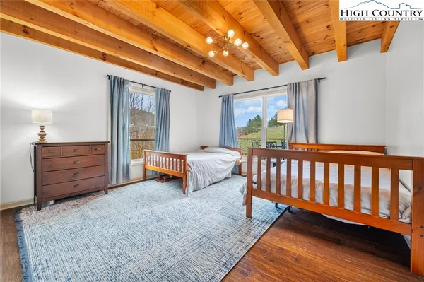 a bedroom with a large bed and a large window