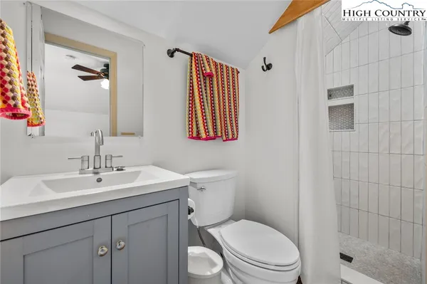 a bedroom with a bed and a view of living room