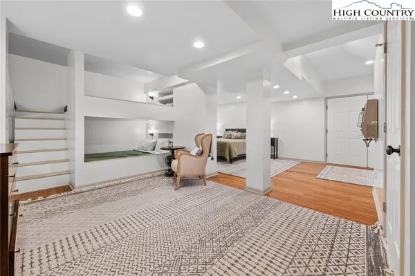 a view of a roof deck with couches and wooden floor