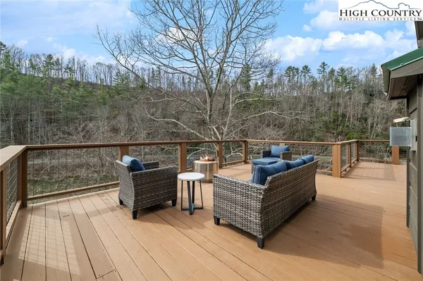 a view of a roof deck with couches and wooden floor
