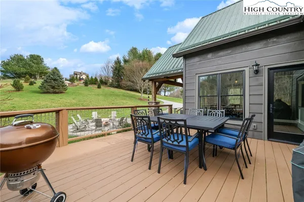 a backyard of a house with a yard and outdoor seating
