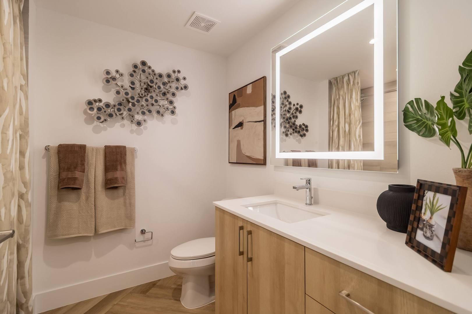 11260 Channing Way, Unit 301 Royal Palm Beach, FL 33414 - Photo 12 of 24 a bathroom with a sink mirror vanity and toilet