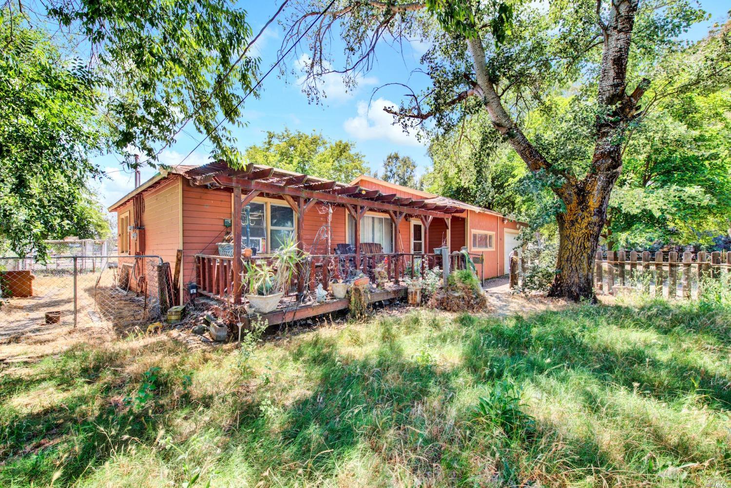 a view of a house with backyard and sitting area