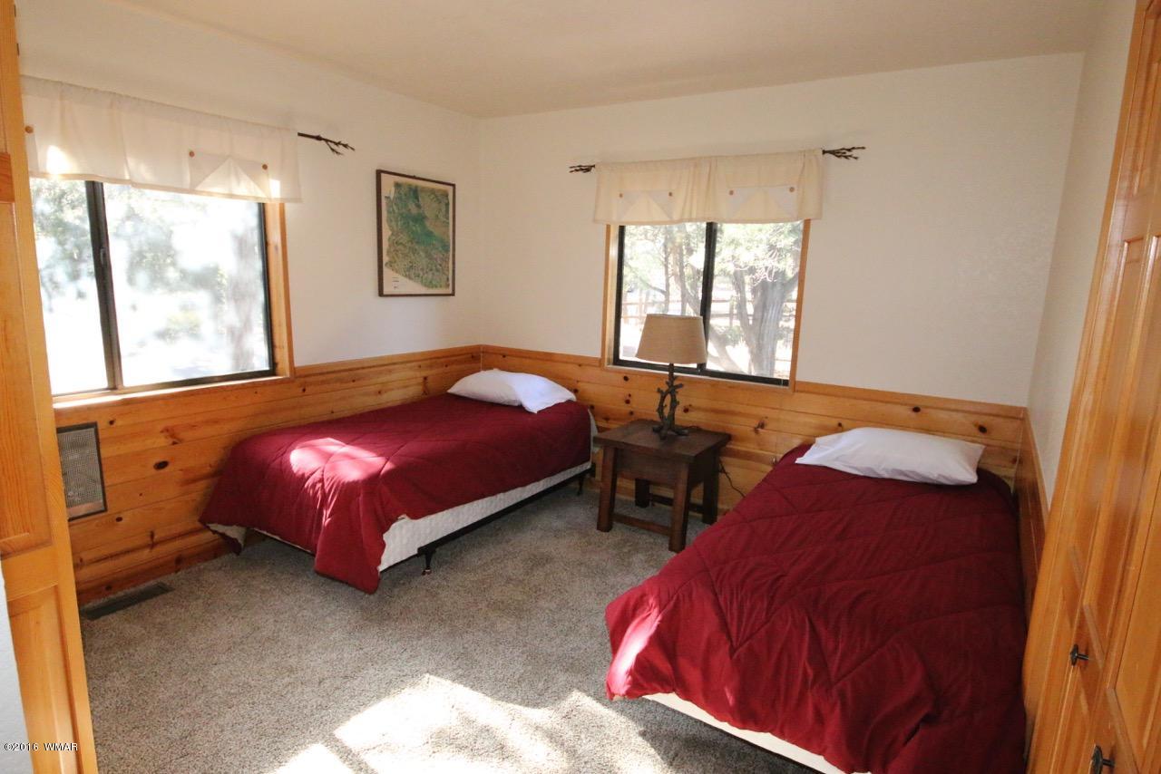 2885 Cedar Ridge Drive Overgaard, AZ 85933 - Photo 20 of 43 a bedroom with a bed and window