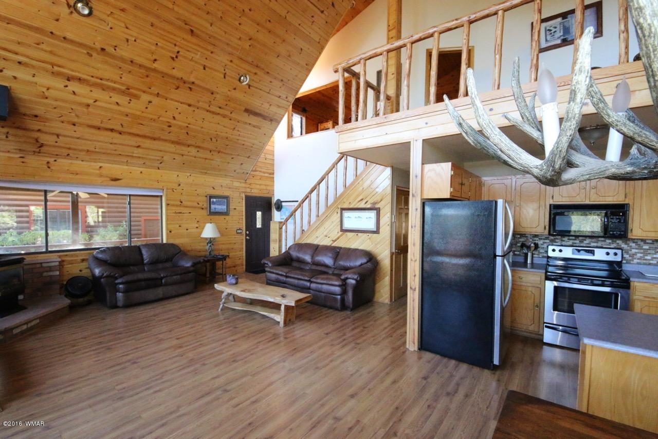 2885 Cedar Ridge Drive Overgaard, AZ 85933 - Photo 4 of 43 a living room with furniture and wooden floor