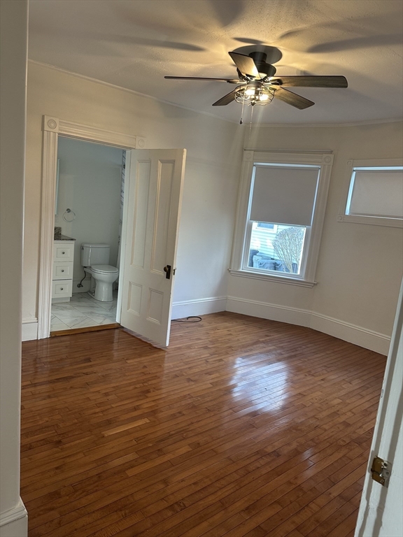 39 Thorndike Street, Unit 1 Beverly, MA 01915 - Photo 4 of 6 a view of an empty room with a window and wooden floor