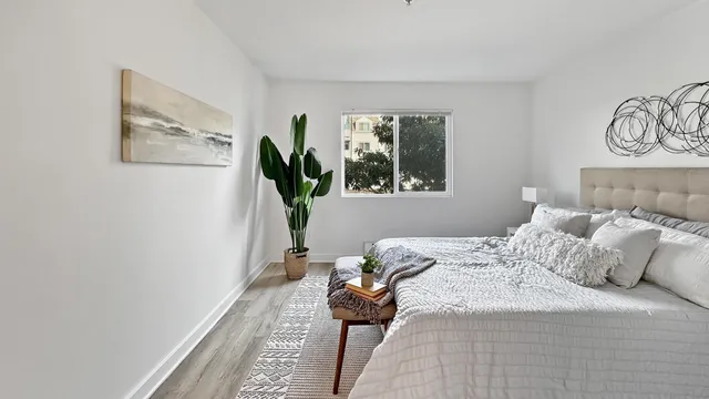 a bedroom with a bed and a window