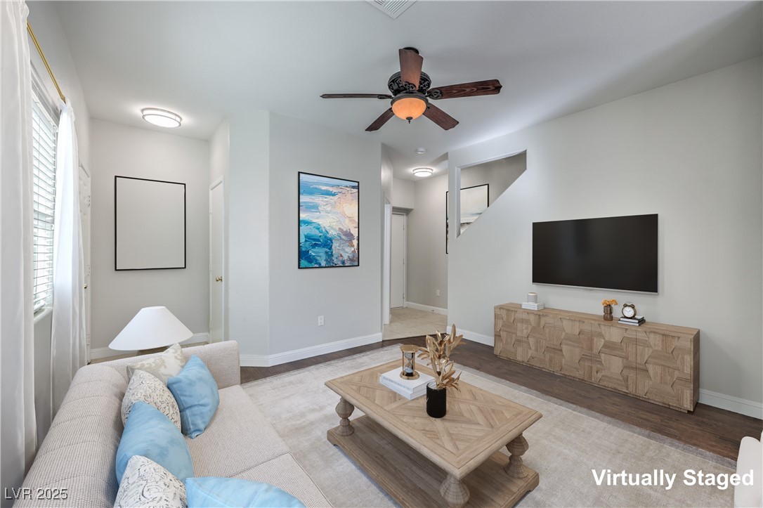 8831 Roping Rodeo Avenue, Unit 102 Las Vegas, NV 89178 - Photo 3 of 47 Spacious living room, garage entry and conveninet lower level 1/2 Bathroom on the right.