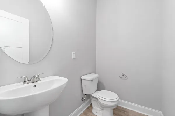 a bathroom with a sink a toilet and mirror