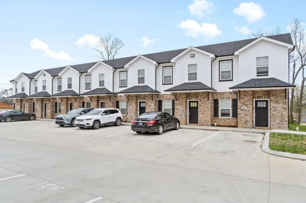 a car parked in front of a white building