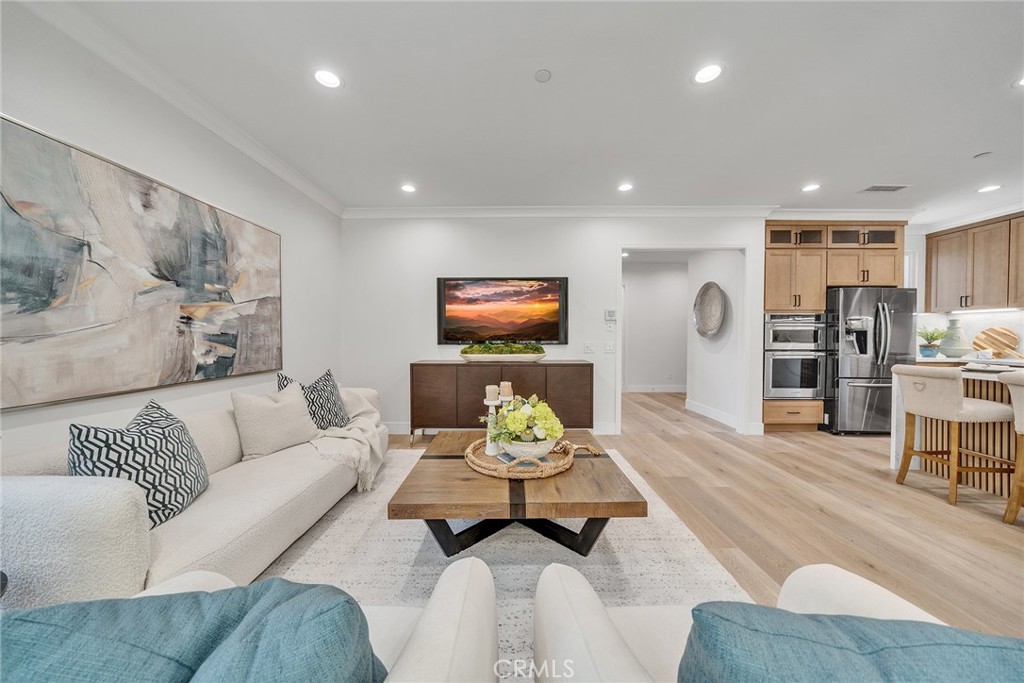 55 Open Range Irvine, CA 92602 - Photo 20 of 66 a living room with furniture and wooden floor
