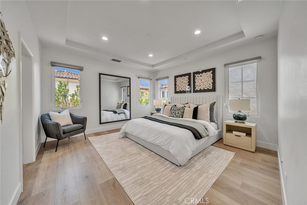 55 Open Range Irvine, CA 92602 - Photo 34 of 66 a spacious bedroom with a large bed and a couch