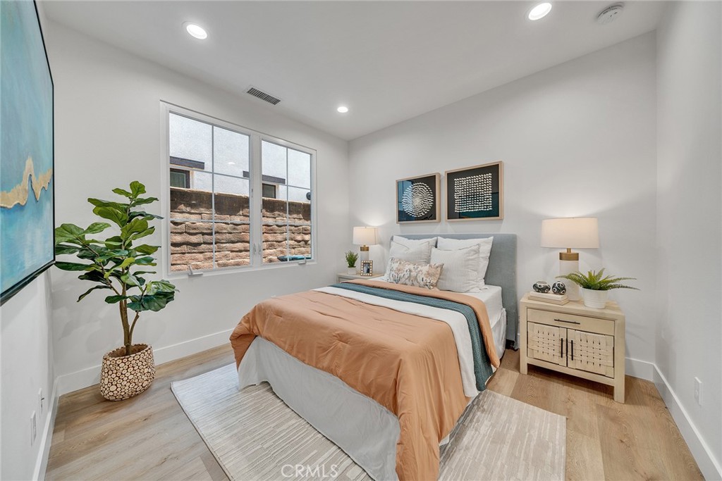 55 Open Range Irvine, CA 92602 - Photo 7 of 66 a bed room with a bed and a potted plant