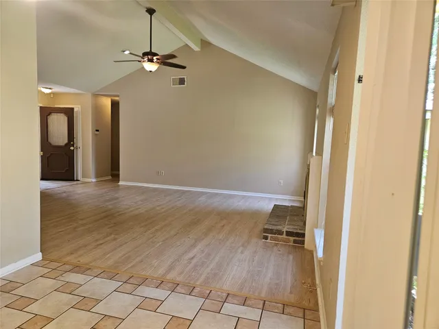 a view of a livingroom and a hallway