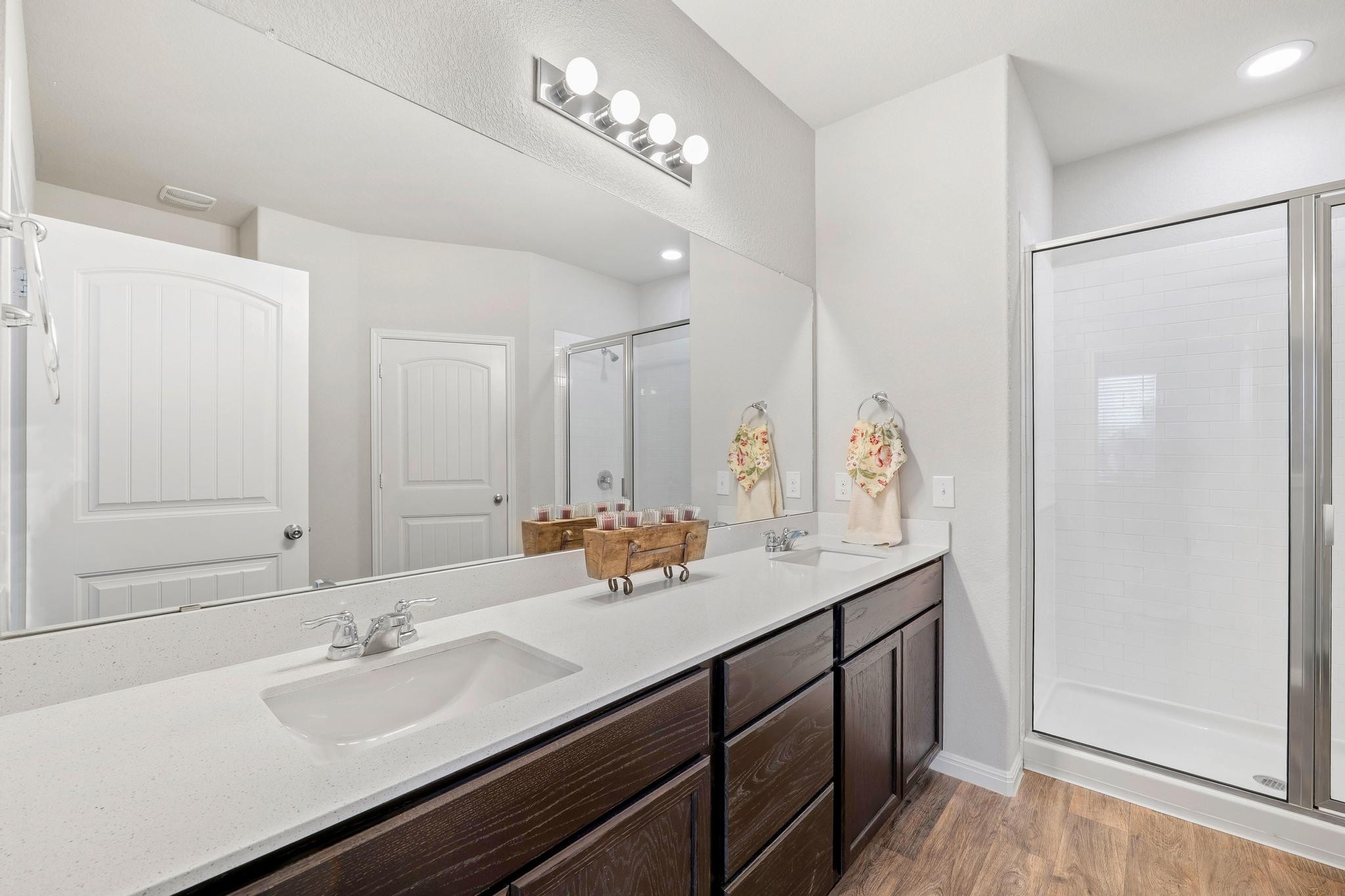 14409 Frankel Loop, Unit 33A Pflugerville, TX 78660 - Photo 15 of 29 Full bathroom featuring a shower stall, double vanity, and light wood-style floors