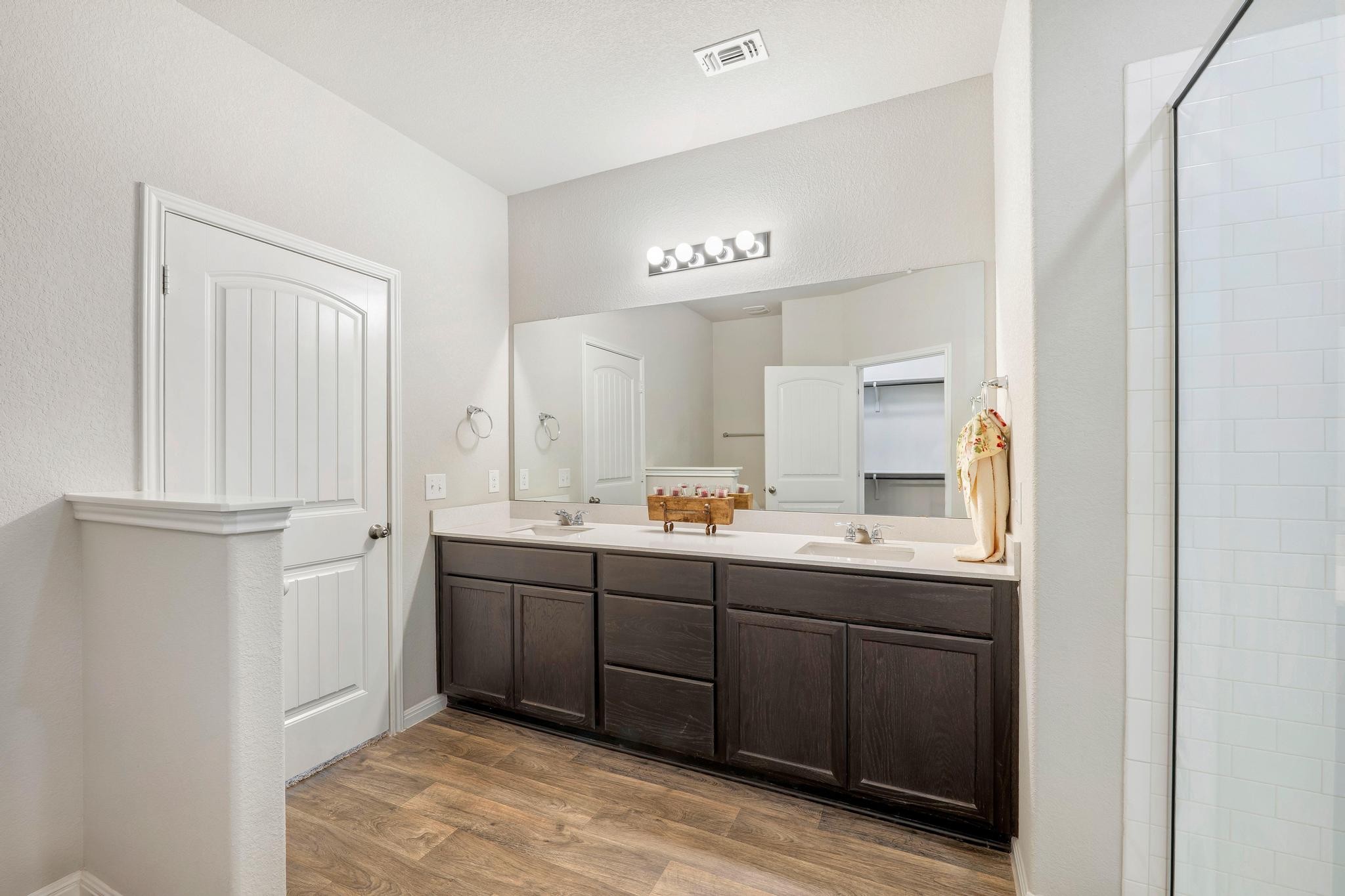 14409 Frankel Loop, Unit 33A Pflugerville, TX 78660 - Photo 16 of 29 Bathroom featuring double vanity, tiled shower, and light wood-style flooring