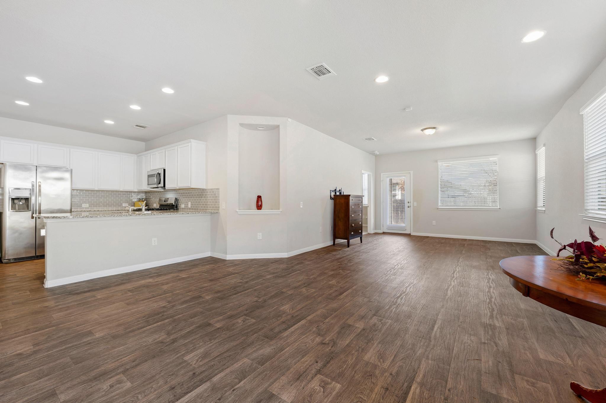 14409 Frankel Loop, Unit 33A Pflugerville, TX 78660 - Photo 7 of 29 Unfurnished living room featuring dark wood-type flooring and recessed lighting